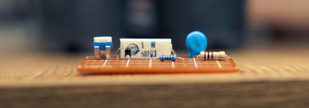 A detailed close-up of electronic components on a circuit board showcasing resistors and capacitors.
